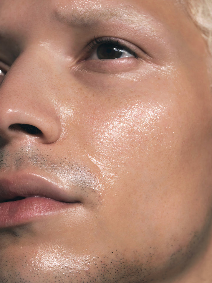 Close up of male's face with SKKN by Kim Night Oil Restoring Treatment on skin