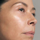 Close up of female's face with SKKN BY KIM Vitamin C8 Serum on skin