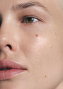 Close up of female's face with SKKN BY KIM Hyaluronic Acid Serum Plumping Hydration on skin