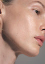 Side of female's face with SKKN BY KIM Oil Drops C-Vita Glow on skin