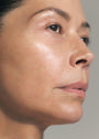 Close up of female's face with SKKN BY KIM Vitamin C8 Serum on skin