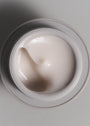Opened ciruclar bottle of SKKN BY KIM Eye Cream Firming Moisturizer